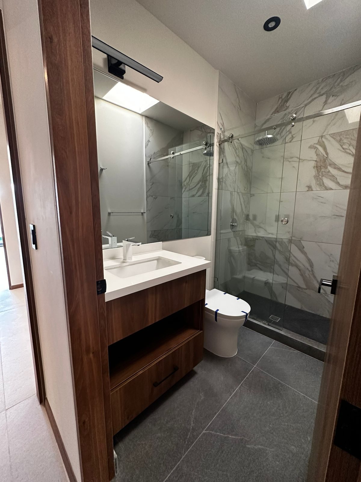 A walnut bathroom vanity built by Cabo