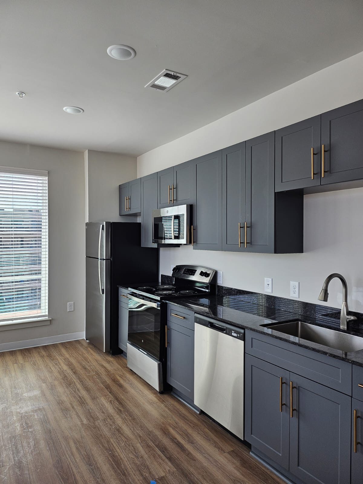 A grey shaker apartment kitchen built by Cabo